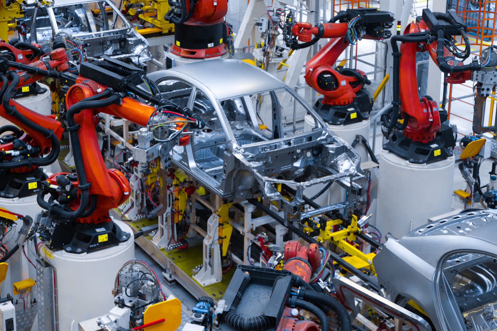 Assembly line production of new car. Automated welding of car body on production line. robotic arm on car production line is working